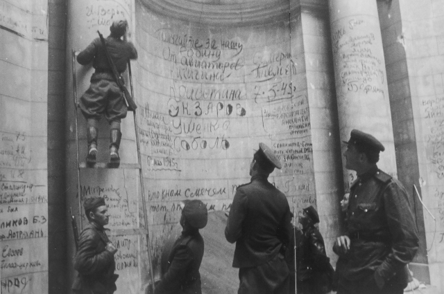 Советские бойцы и командиры оставляют победные надписи и свои фамилии на стенах Рейхстага. Май 1945 года